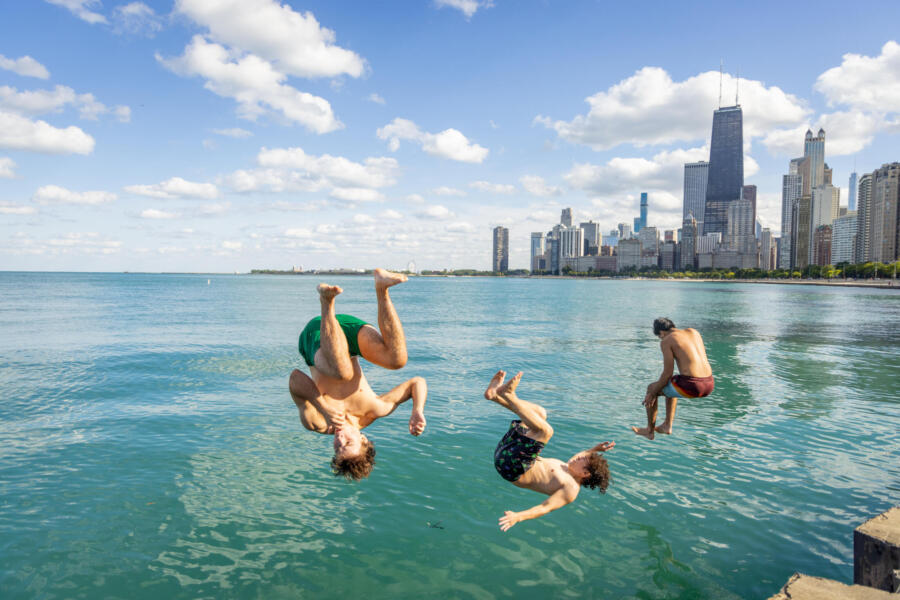 A group of friends jump in the water at North Avenue Beach