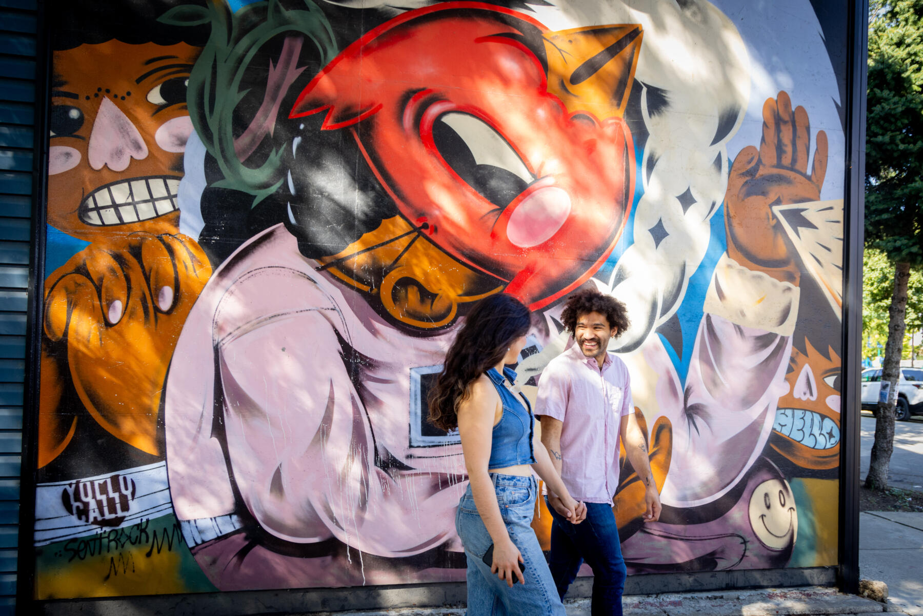 Couple Walks By Artistic Mural in Pilsen Neighborhood in Chicago
