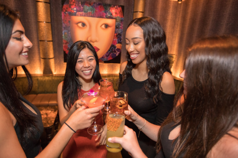 Friends enjoying a girls night clank drinks together at TAO Chicago on new year's eve.