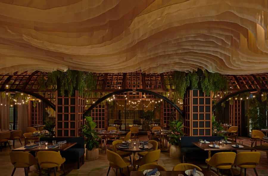 Scenic dinner setup at Alla Vita Chicago with candles and plates set across tables.