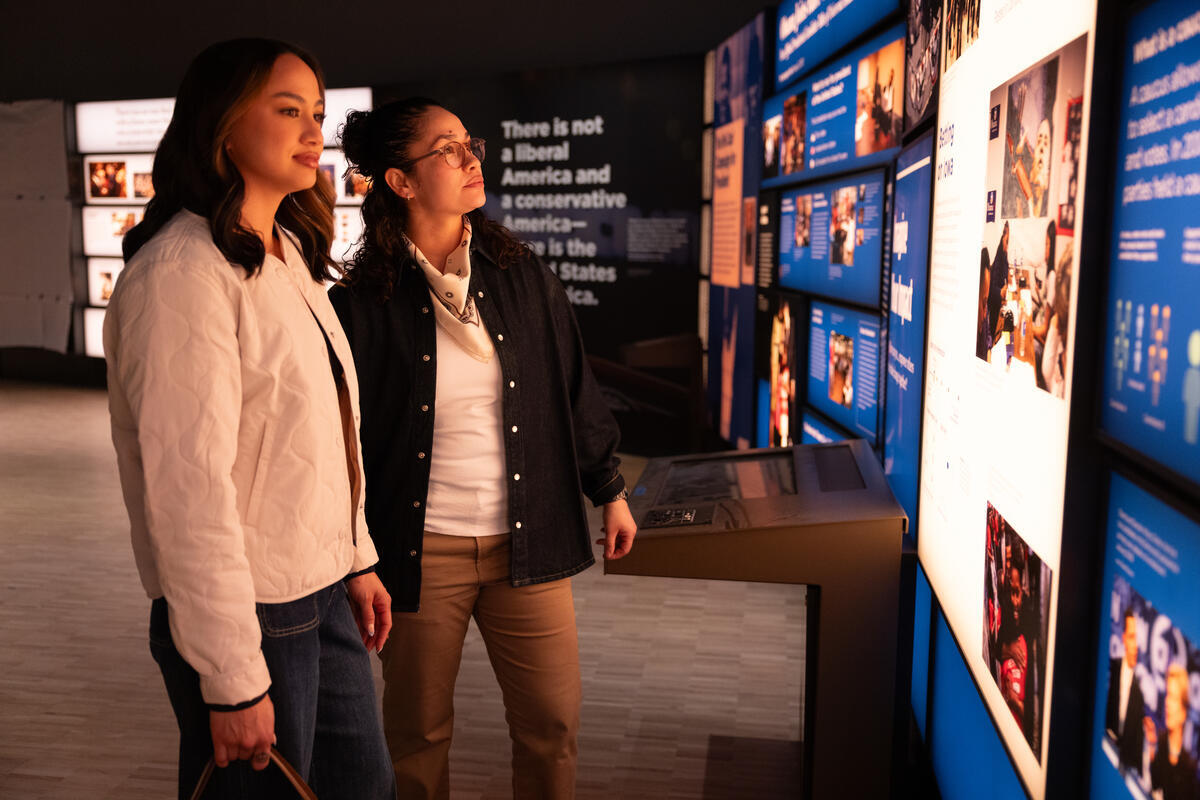Two visitors check out a display at the Obama Presidential Center in Chicago.